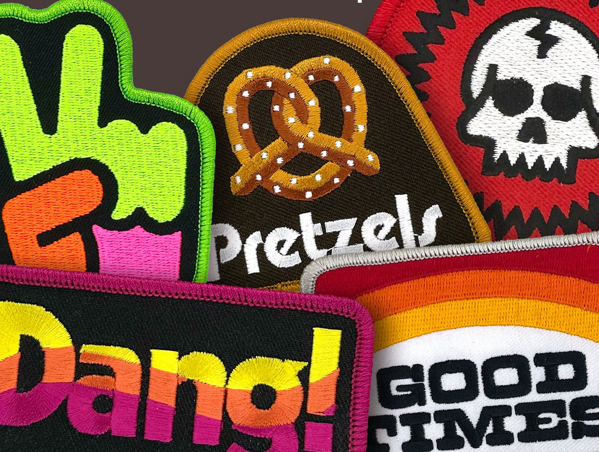 Close-up of Draplin Design Co. embroidered patches in bright flat color