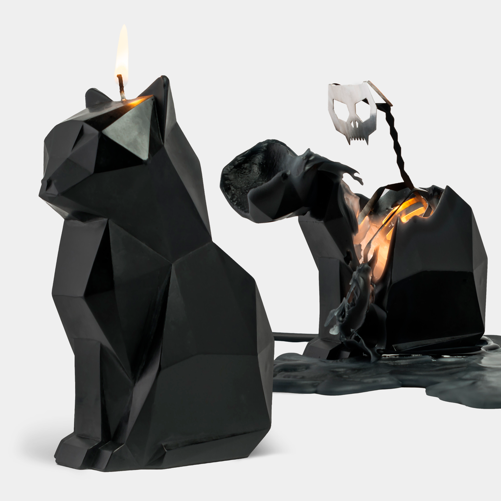 PyroPet Kisa black cat candle beside the same candle burned down to its metal skeleton