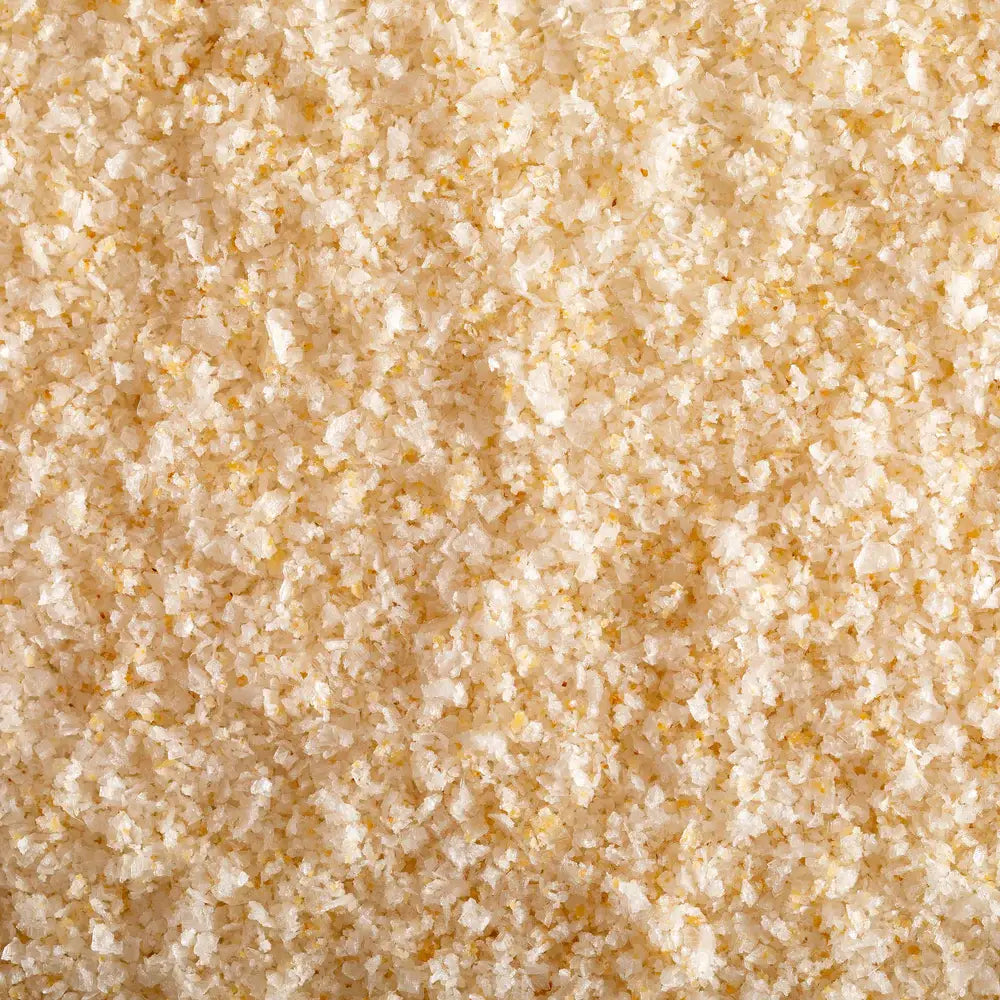 Close up of pale golden garlic sea salt crystals