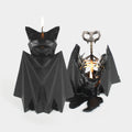 PyroPet Blaka black bat candle beside the same candle burned down to its winged metal skeleton