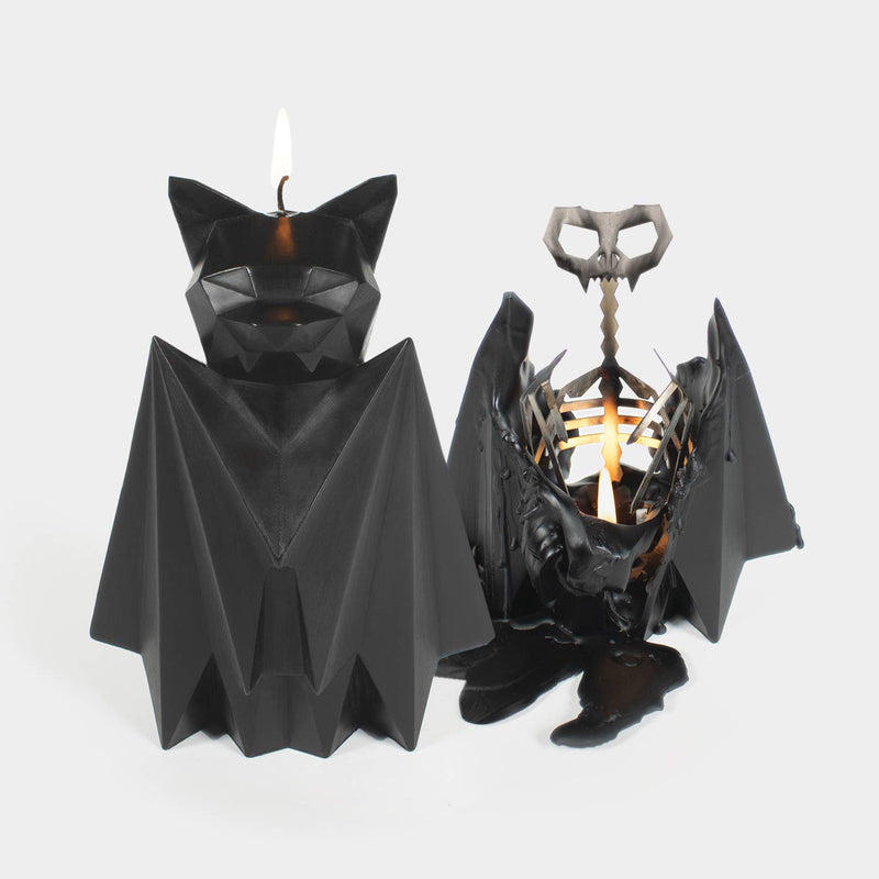 PyroPet Blaka black bat candle beside the same candle burned down to its winged metal skeleton
