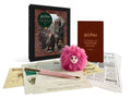 Harry Potter Diagon Alley set: a fluffy pink Pygmy Puff plush, Hagrid's pink umbrella pen, a map and Daily Prophet sheets in front of a dark keepsake box