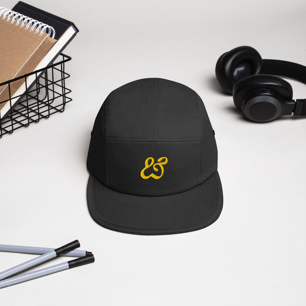 The black Moss and Fog five panel cap photographed straight on from the front