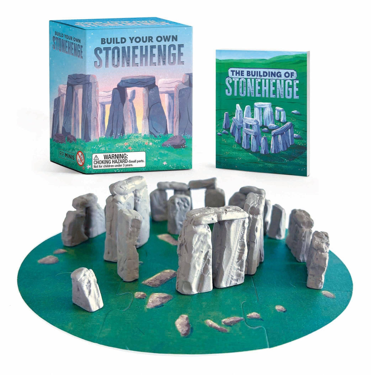Build Your Own Stonehenge kit: a ring of small grey stones standing on a round green map, with the box and a blue illustrated guide behind