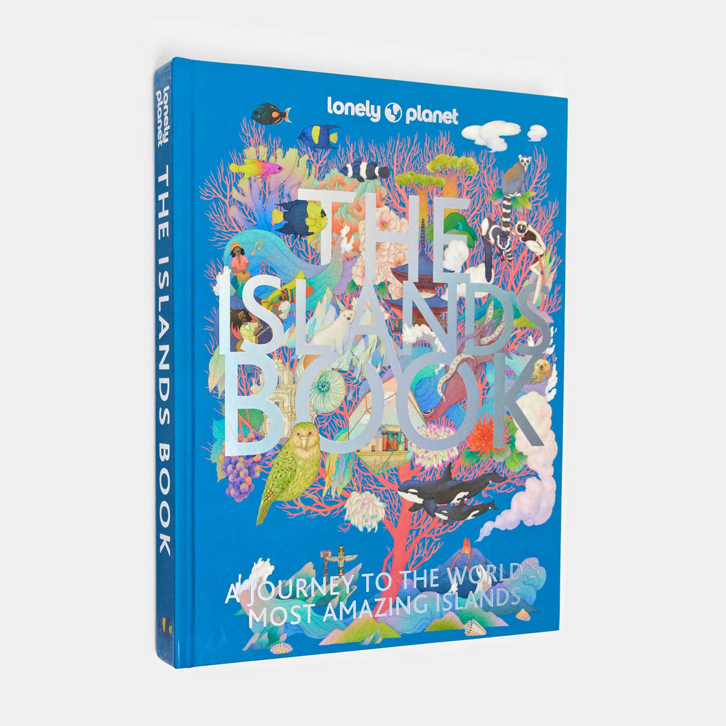 The Islands Book hardcover from Lonely Planet: a bright blue cover crowded with illustrated birds, plants and sea creatures behind the title