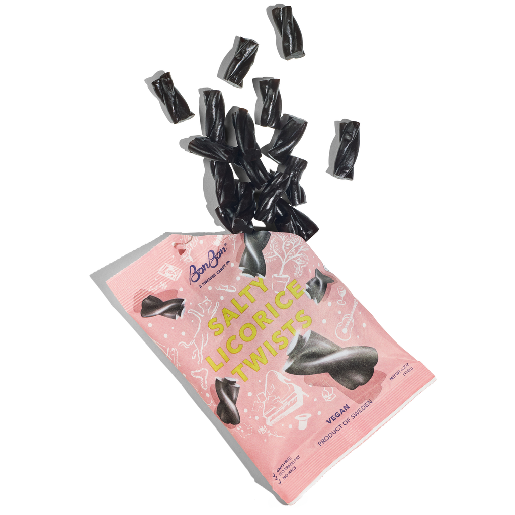 Black salty licorice twists spilling out of a pink BonBon bag