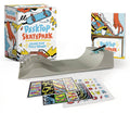 Desktop Skatepark box with a grey miniature ramp, sticker sheets and a small skateboard laid out beside it