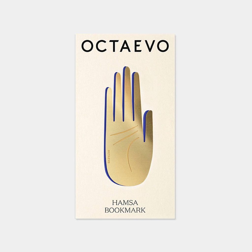 Hamsa brass bookmark by Octaevo, a die cut open hand in varnished brass on its postcard mount