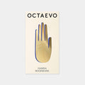 Hamsa brass bookmark by Octaevo, a die cut open hand in varnished brass on its postcard mount