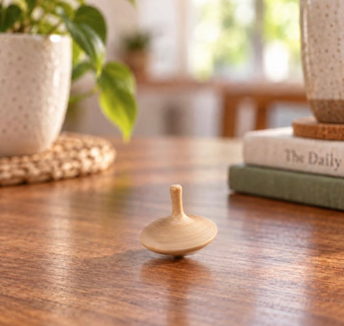 Hand carved oak spinning top with visible wood grain