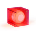BANG Lop light in electric pink cast acrylic, stacked sheets glowing around a warm central disc