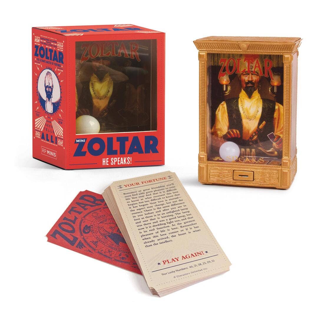 Mini Zoltar box beside the gold fortune teller booth and a fan of printed fortune cards