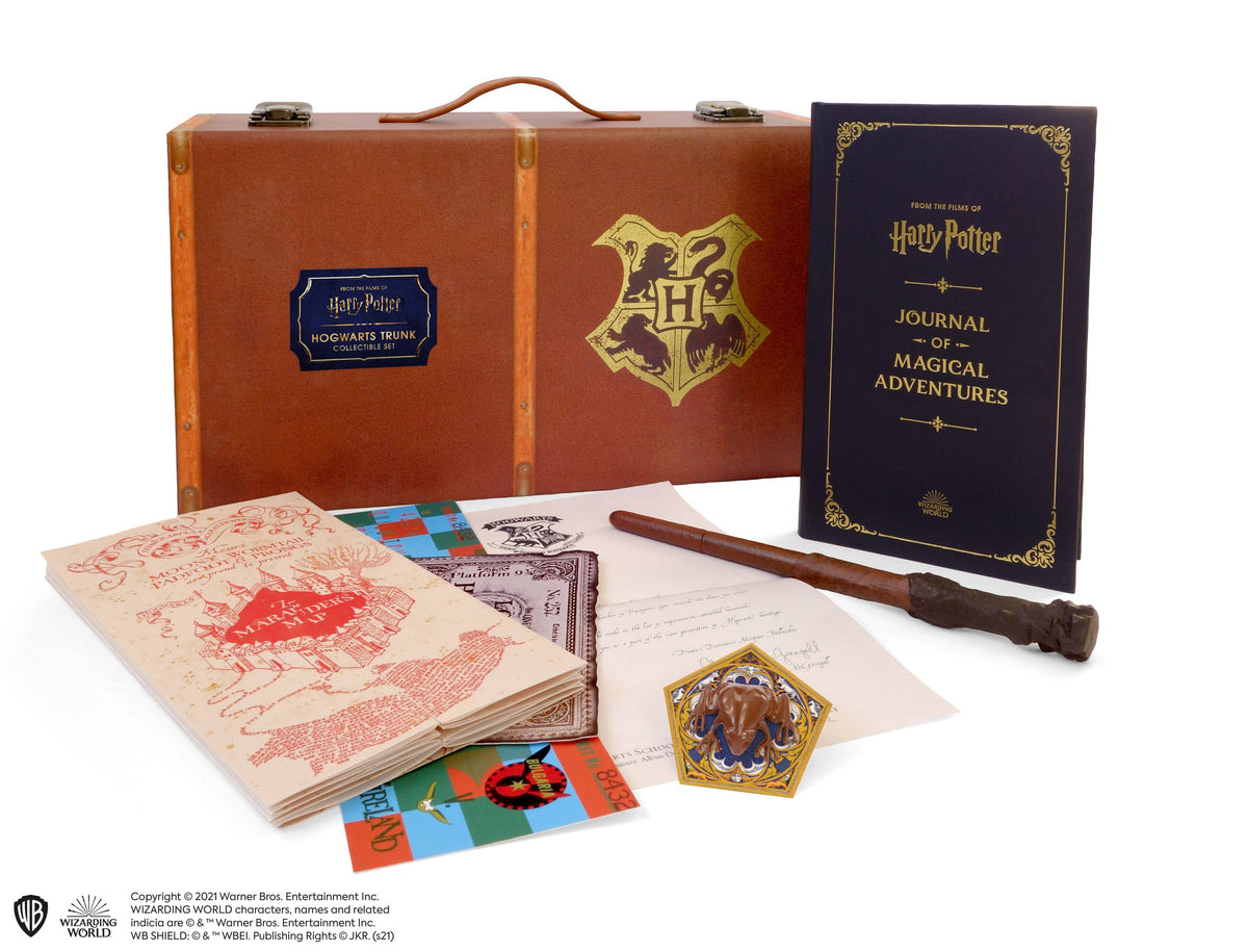 Harry Potter Hogwarts Trunk set: a tan trunk with a Hogwarts crest, an open journal, a folded Marauder's Map, a wand pen and a gold Chocolate Frog card