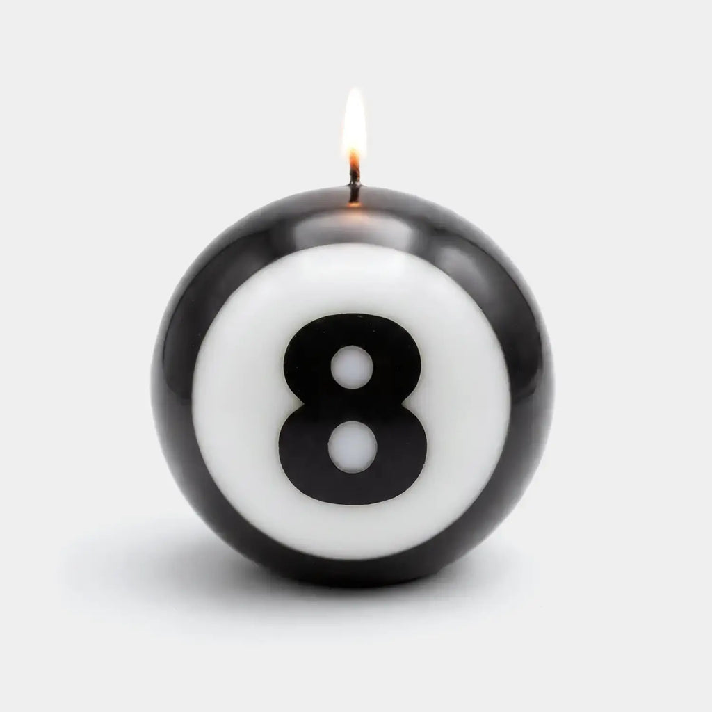 Classic 8-Ball candle lit on a white ground, the eight centered on the sphere