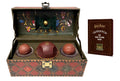Harry Potter Quidditch Set: an open leather-look trunk with a red Quaffle, two dark Bludgers and a tiny Golden Snitch inside, beside a small brown playbook