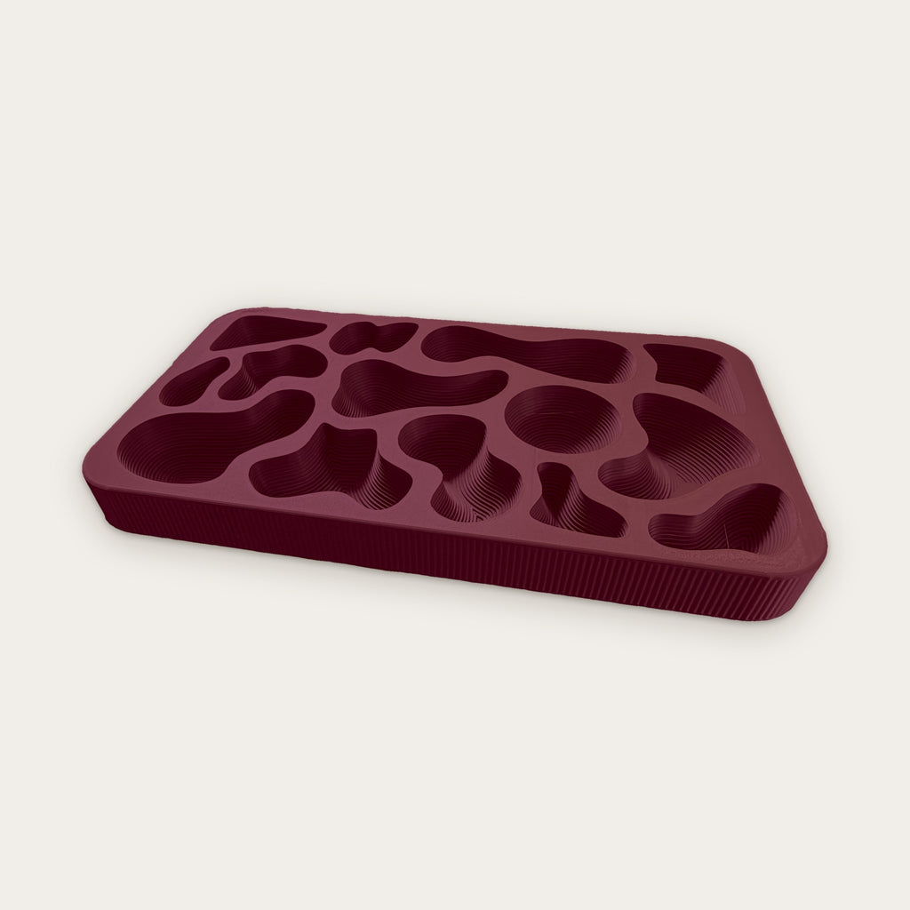 Topography Tray in Burgundy, a deep wine red with terraced wells and fluted sides