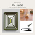 The Desk Set gift from Moss & Fog: a green op-art Geometric Tray, a hand-carved oak spinning top and black U-shaped scissors
