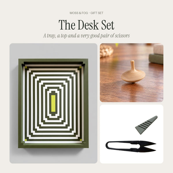The Desk Set gift from Moss & Fog: a green op-art Geometric Tray, a hand-carved oak spinning top and black U-shaped scissors